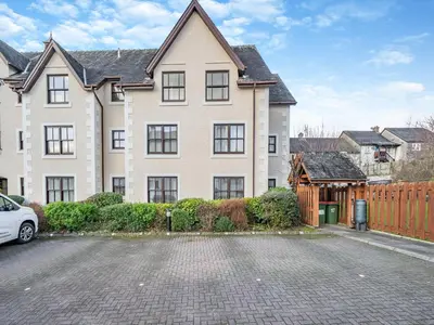 a large house with a car parked in front of it at Olivet - Hewetson Court in Keswick
