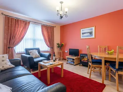a living room with a couch and a table at Beech Nut in Keswick
