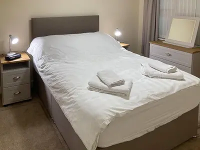 a bedroom with a bed with two towels on it at Ashbrooke- Hewetson Court in Keswick