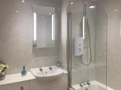 a bathroom with a sink and a shower at Ashbrooke- Hewetson Court in Keswick