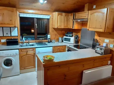 a kitchen with a sink and a stove top oven at Ewe How - Burnside Park in Keswick