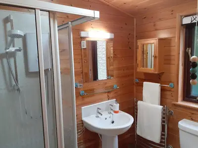 a bathroom with a white sink and a shower at Ewe How - Burnside Park in Keswick