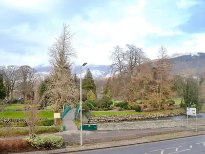 a street light in a park with mountains in the background at Shorley Lodge in Keswick
