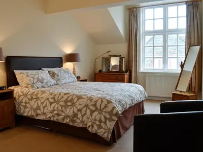 a bedroom with a large bed and a window at Bay Tree in Keswick