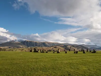 a green field with a mountain in the background at Bay Tree in Keswick