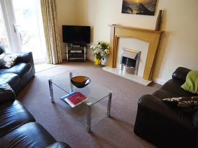 a living room with a couch and a fireplace at Carthwaite in Keswick