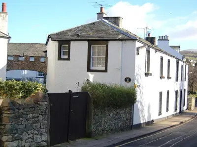 a white house on the side of a street at Acorn Lodge Cottage in Keswick
