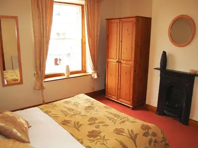 a bedroom with a bed and a window at Alvamere in Keswick