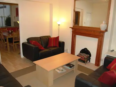 a living room with two couches and a table at The Ivy Cottage in Keswick