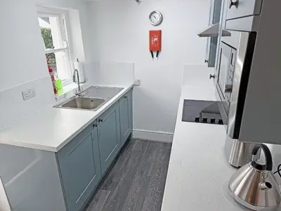 a kitchen with a sink and a counter top at 1 Windsor House in Keswick
