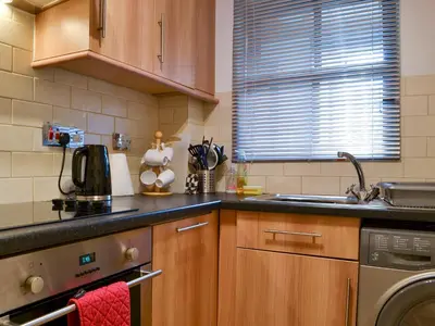 a kitchen with a sink and a dishwasher at Bleaberry- Hewetson Court in Keswick