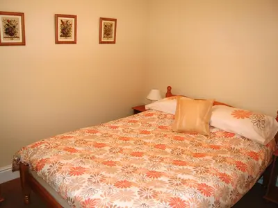a bedroom with a bed and two pillows on it at Helvellyn House Apartment in Keswick