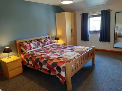a bedroom with a bed with a colorful bedspread at Wickhams View in Keswick