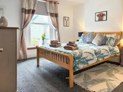 a bedroom with a bed with towels on it at Lavender Cottage in Keswick