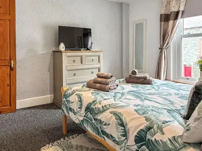 a bedroom with a bed with towels on it at Lavender Cottage in Keswick