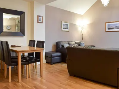 a living room with a table and a couch at The Old Laundry 1 in Keswick