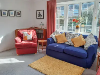 a living room with a blue couch and a red chair at Peel Wyke in Keswick