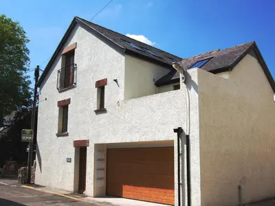 a white house with a large garage at The Old Laundry 3 in Keswick