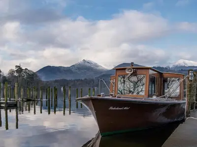 a boat is docked at a dock in the water at The Old Laundry 3 in Keswick