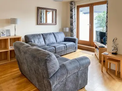 a living room with a couch and a couch and a table at The Old Laundry 4 in Keswick