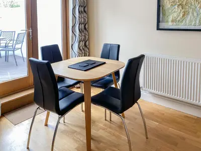 a dining room table with four chairs and a table at The Old Laundry 4 in Keswick