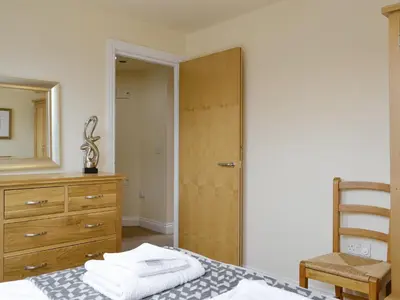 a bedroom with a bed and a dresser and a closet at The Old Laundry 4 in Keswick
