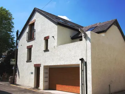 a white house with a large garage at The Old Laundry 4 in Keswick