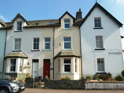 a white house with a car parked in front of it at York House in Keswick