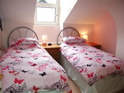 two beds sitting next to each other in a bedroom at York House in Keswick