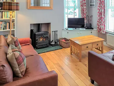 a living room with a couch and a wood stove at Hastings in Keswick