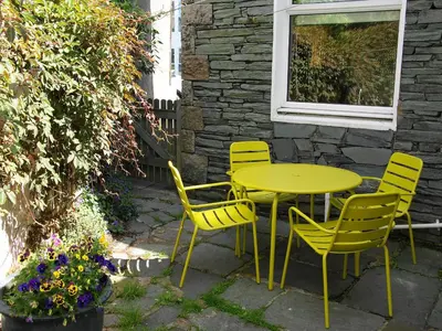 a yellow table and chairs on a patio at Hastings in Keswick