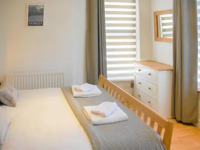a bedroom with a bed with two towels on it at Hastings in Keswick