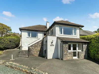 a white house with a driveway in front of it at The Croft in Keswick