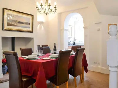 a dining room with a red table and chairs at Green Ghyll in Keswick