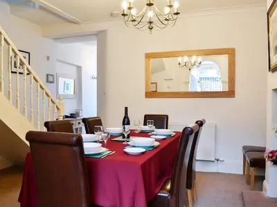 a dining room with a table with a red table cloth at Green Ghyll in Keswick