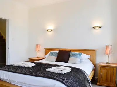 a bedroom with a bed with two towels on it at Green Ghyll in Keswick