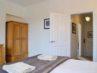 a bedroom with a bed with two towels on it at Green Ghyll in Keswick