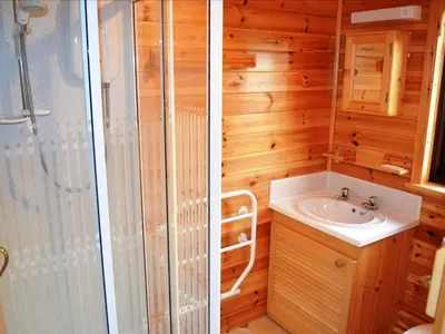 two pictures of a bathroom with a shower and a sink at Glenmore Lodge in Keswick