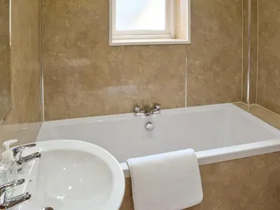 a bathroom with a sink and a bath tub at Falcon Crag in Keswick