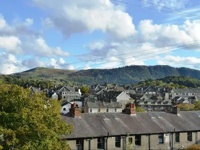 a town with houses and mountains in the background at Valentine Cottage in Keswick