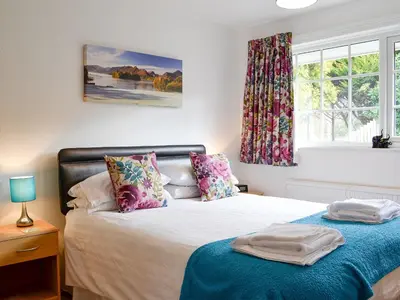 a bedroom with a bed and a window at Haystacks in Keswick