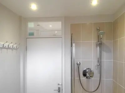 a bathroom with a shower with a glass door at The Bolthole Formerly Candlemas in Keswick