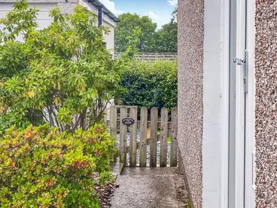 a wooden gate in front of a house at The Bolthole Formerly Candlemas in Keswick