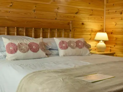 a bedroom with a bed with pillows on it at Fern Lodge- Burnside Park in Keswick