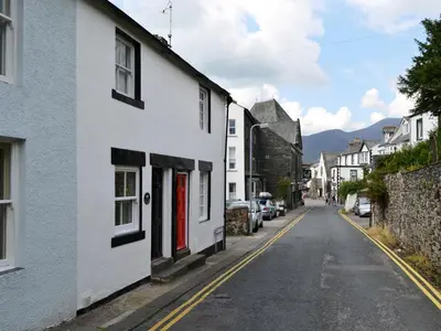 an empty street in a town with white houses at 4 The Plosh in Keswick