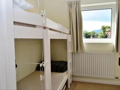a bunk bed in a room with a window at 5 The Plosh in Keswick