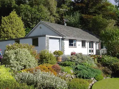 a white house with a garden in front of it at Manesty in Applethwaite