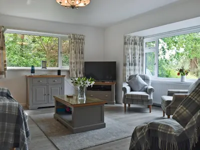 a living room with a couch and a tv at Manesty in Applethwaite