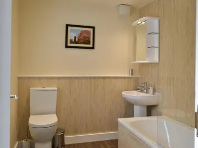 a bathroom with a toilet and a sink at Causey Cottage in Keswick