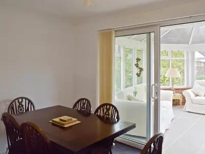 a dining room with a table and chairs at Polperro in Keswick